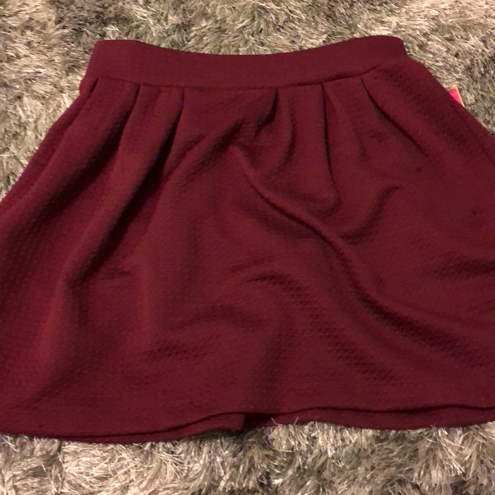 Candie’s pleated maroon skirt